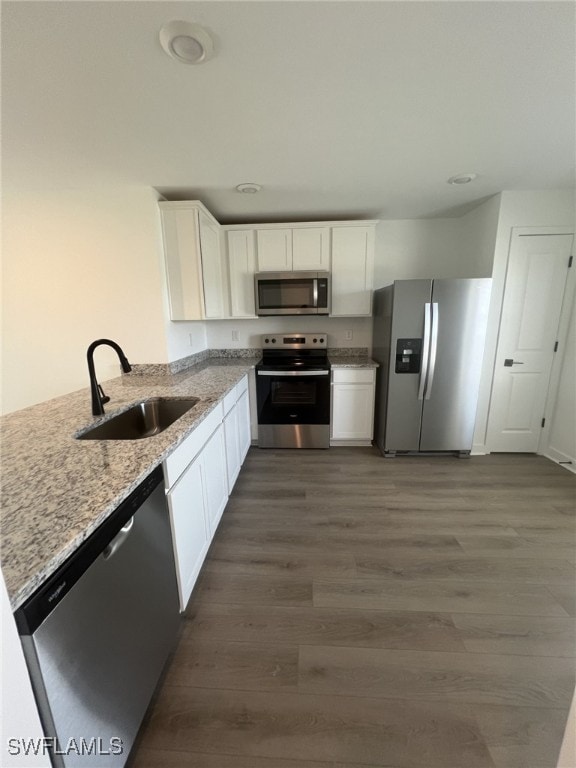 249 Blackstone Dr, Fort Myers, FL 33913 - kitchen featuring stainless steel appliances, a sink, light stone countertops, and white cabinetry
