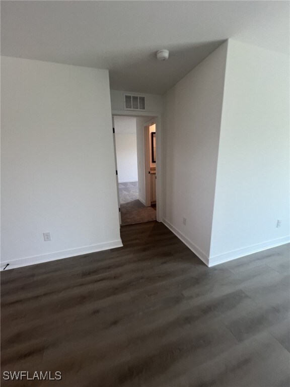 249 Blackstone Dr, Fort Myers, FL 33913 - spare room with a smoke detector, baseboards, and dark wood-style floors