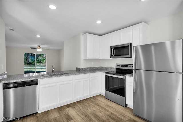 kitchen with ceiling fan, sink, light hardwood / wood-style flooring, white cabinetry, and appliances with stainless steel finishes