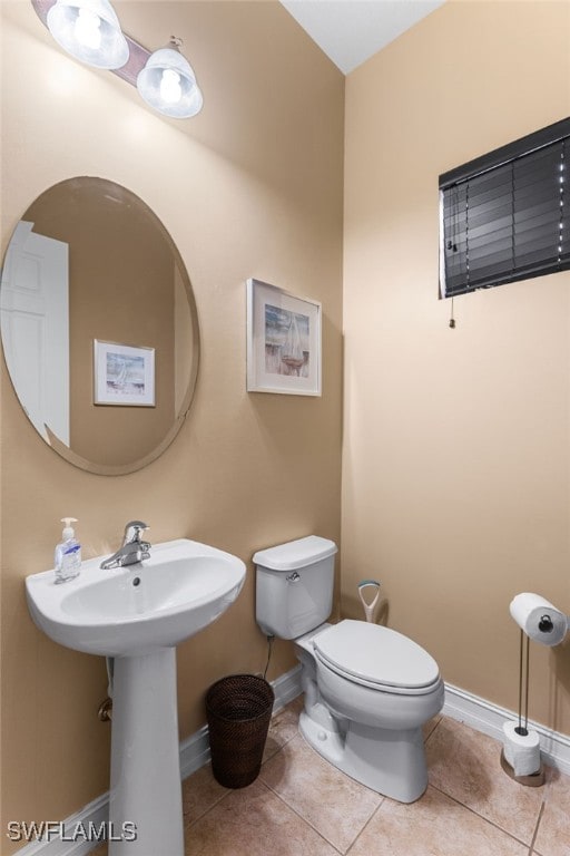 bathroom with tile patterned flooring and toilet