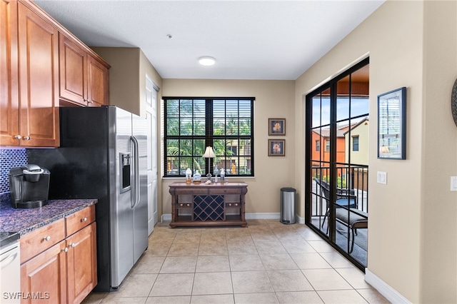 kitchen featuring dark stone counters and light tile patterned floors