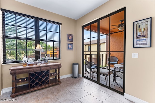 interior space with ceiling fan