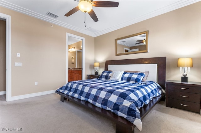 bedroom with ceiling fan, ensuite bath, light carpet, and crown molding