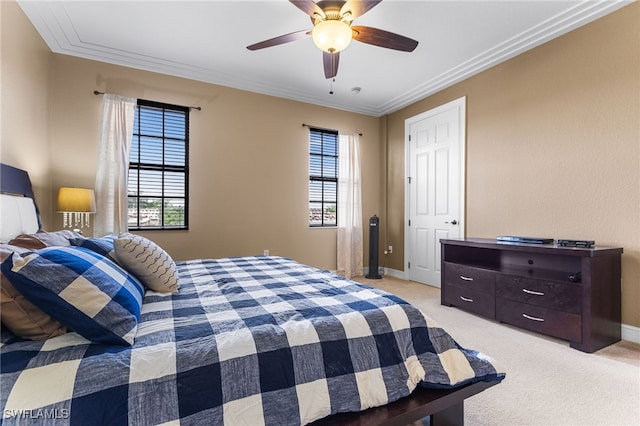 bedroom with light carpet, ceiling fan, and ornamental molding