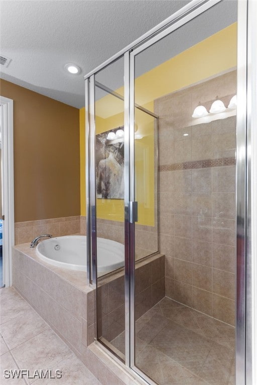 bathroom featuring a textured ceiling, plus walk in shower, and tile patterned floors