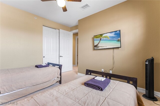 bedroom featuring light carpet, a closet, and ceiling fan