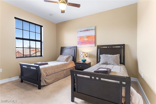 bedroom with ceiling fan and light colored carpet