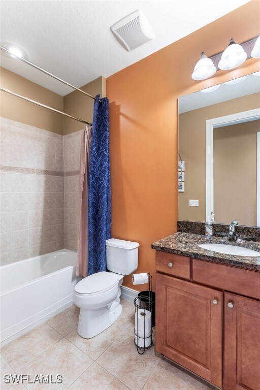 full bathroom with vanity, tile patterned flooring, toilet, and shower / bath combo