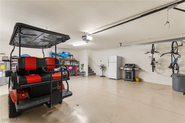 garage featuring a garage door opener and white fridge