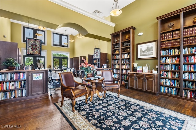 sitting room featuring ornamental molding, a towering ceiling, and dark hardwood / wood-style flooring