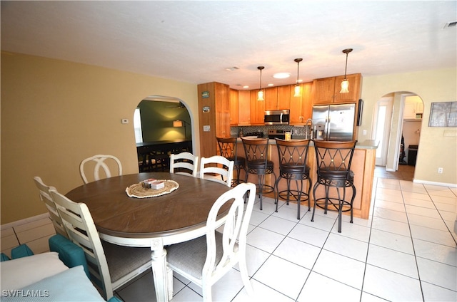 dining area with light tile patterned floors and sink