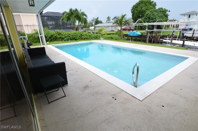 view of pool with a lanai and a patio area