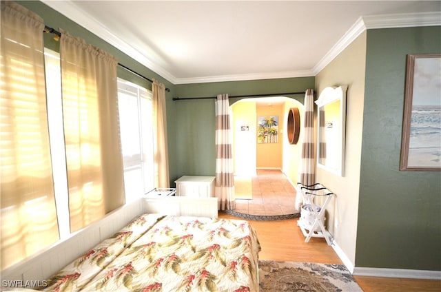 bedroom featuring wood-type flooring and crown molding