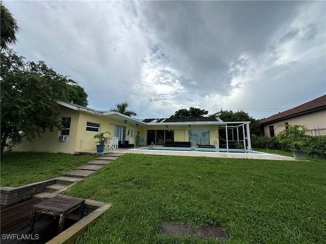 rear view of house featuring a patio area and a yard