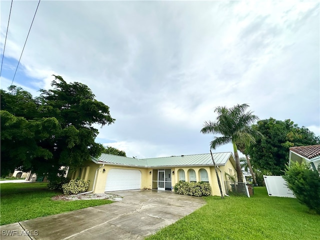 single story home featuring a front lawn and a garage