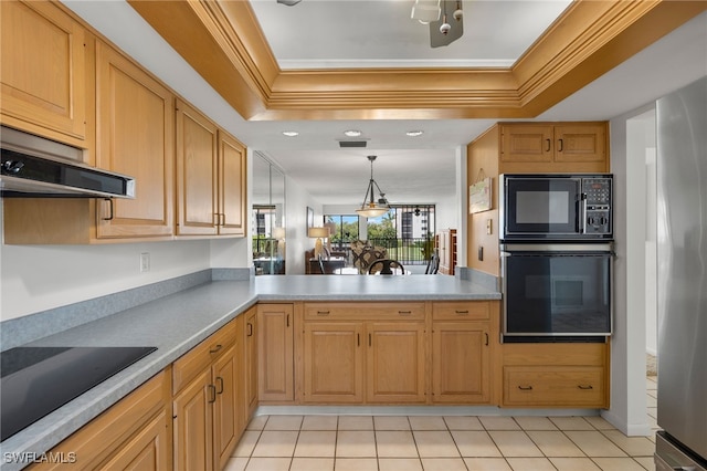 kitchen with black appliances, light tile patterned floors, a raised ceiling, and kitchen peninsula