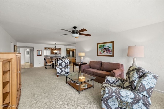 carpeted living room with ceiling fan