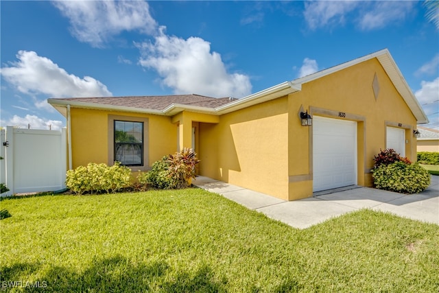 view of front of property with a garage and a front yard