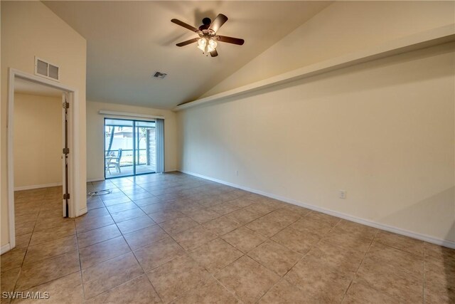 tiled spare room with lofted ceiling and ceiling fan