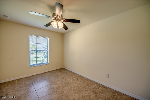 tiled empty room featuring ceiling fan