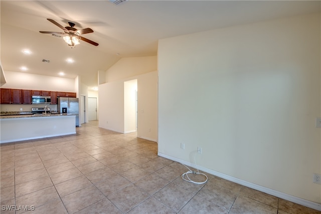 unfurnished living room featuring lofted ceiling, ceiling fan, and light tile patterned floors