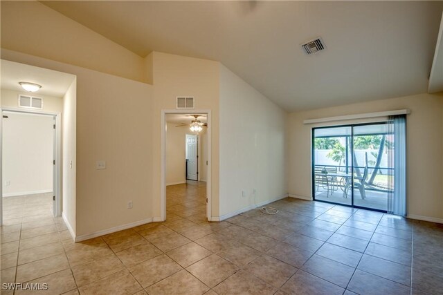 spare room featuring lofted ceiling, ceiling fan, and light tile patterned floors