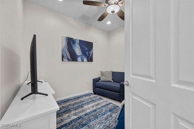 living area featuring ceiling fan