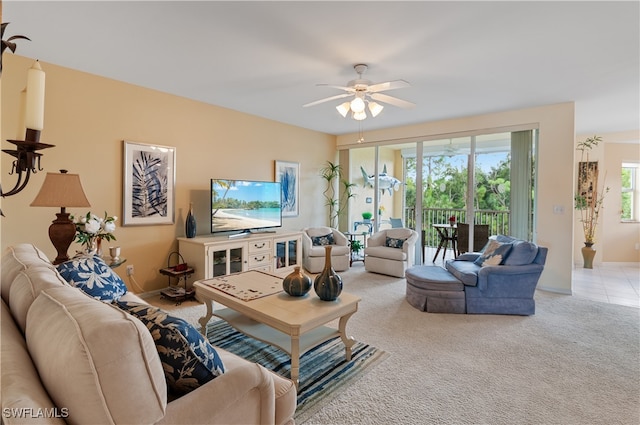 carpeted living room featuring ceiling fan and a wealth of natural light