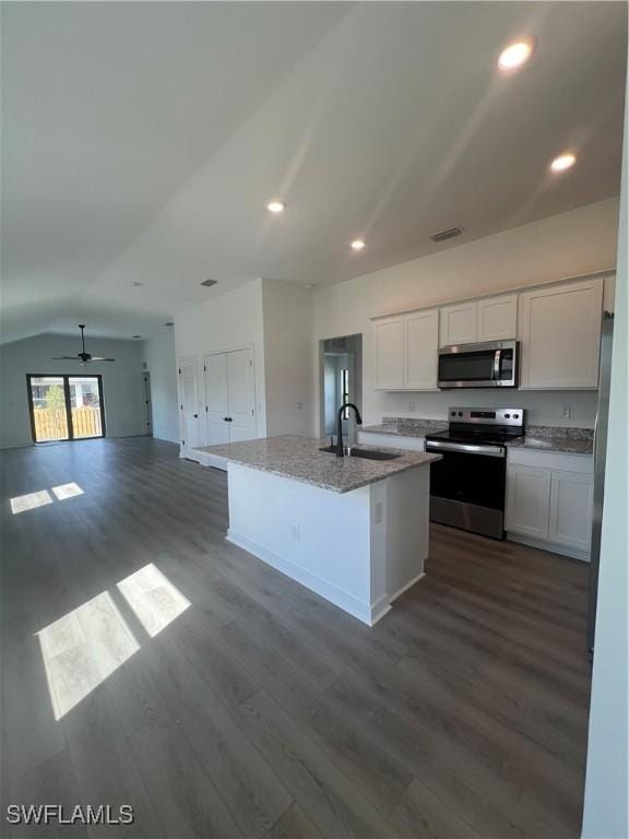 kitchen with white cabinetry, sink, a kitchen island with sink, stainless steel appliances, and dark wood-type flooring