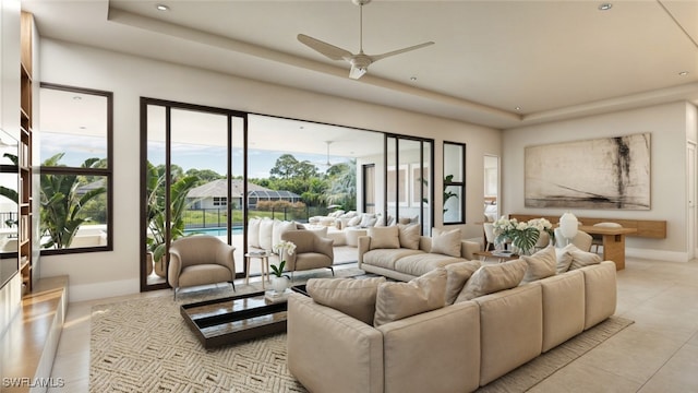 living room with a raised ceiling and ceiling fan