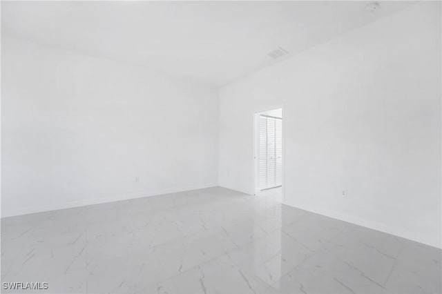 2602 73rd St W, Lehigh Acres, FL 33971 - empty room featuring marble finish floor and baseboards