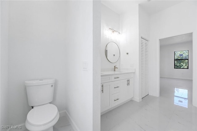 2602 73rd St W, Lehigh Acres, FL 33971 - bathroom with baseboards, marble finish floor, toilet, and vanity