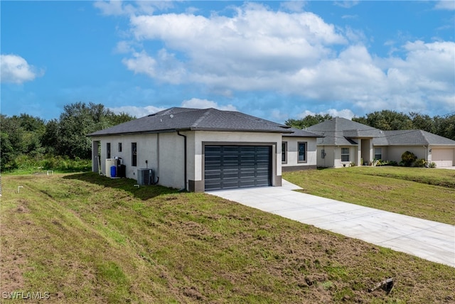 view of front facade with cooling unit, a garage, and a front lawn