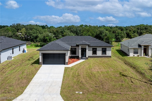 view of front facade with cooling unit, a garage, and a front lawn