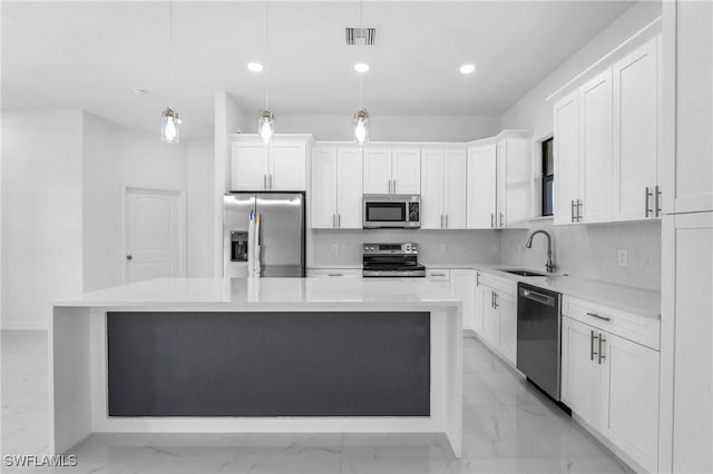 2602 73rd St W, Lehigh Acres, FL 33971 - kitchen featuring stainless steel appliances, marble finish floor, a kitchen island, a sink, and visible vents