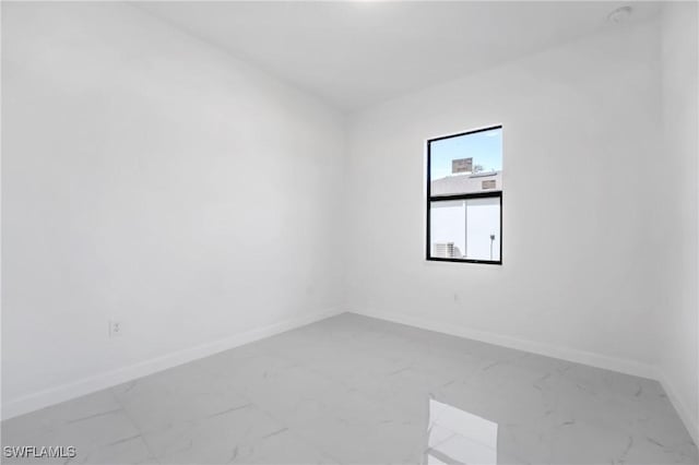 2602 73rd St W, Lehigh Acres, FL 33971 - empty room featuring marble finish floor and baseboards