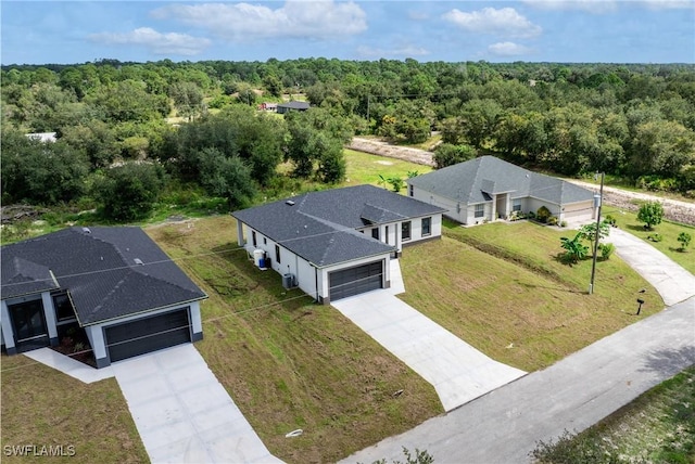 2602 73rd St W, Lehigh Acres, FL 33971 - drone / aerial view with a forest view