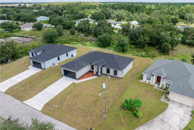 2602 73rd St W, Lehigh Acres, FL 33971 - birds eye view of property with a view of trees