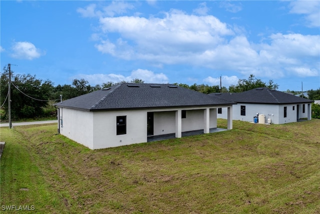 back of property featuring a yard and a patio area