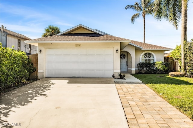 single story home featuring a front yard and a garage