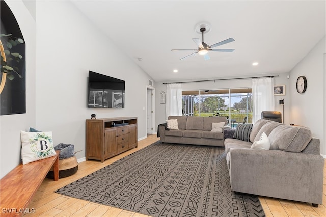 living room featuring lofted ceiling, ceiling fan, and light hardwood / wood-style floors