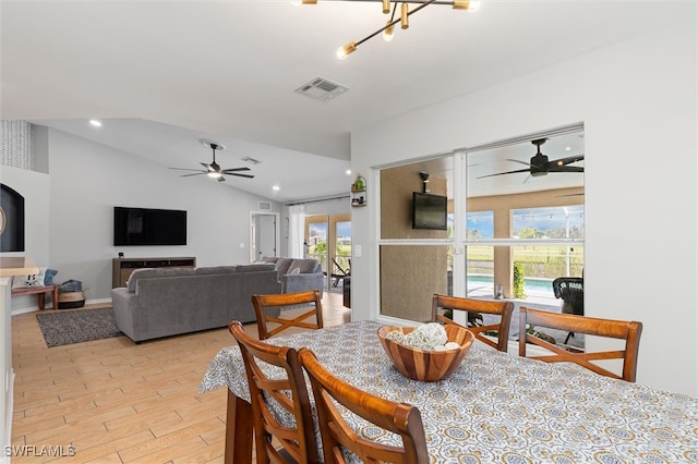 dining room featuring vaulted ceiling, light wood-type flooring, and ceiling fan