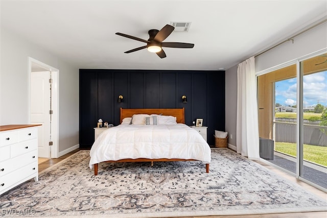 bedroom with access to outside and ceiling fan