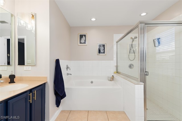 bathroom with tile patterned flooring, vanity, and shower with separate bathtub