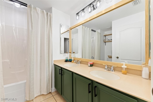 bathroom with tile patterned floors, shower / bath combo with shower curtain, and vanity