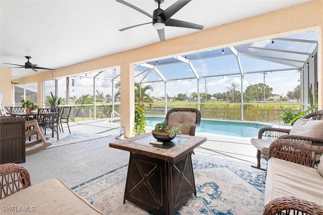 view of patio / terrace featuring glass enclosure and ceiling fan