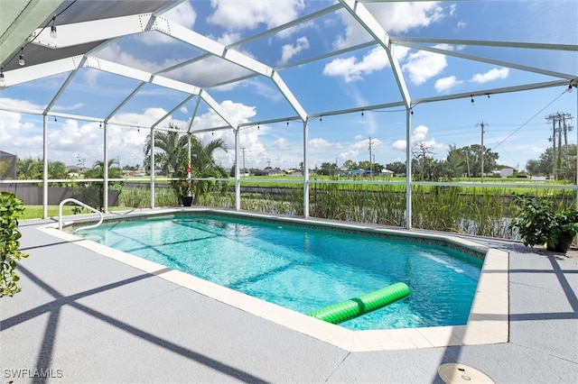 view of pool featuring a water view, a lanai, and a patio