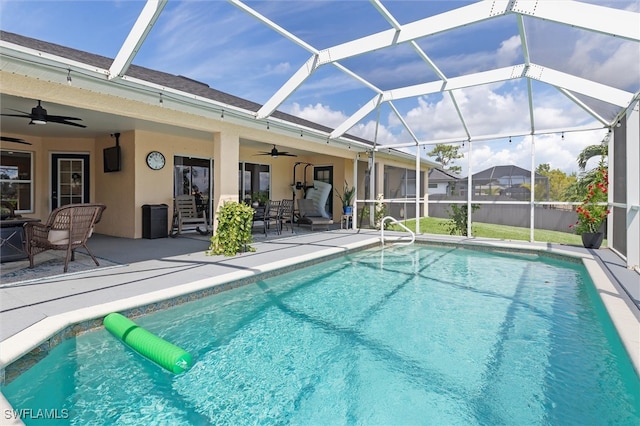 view of swimming pool with a lanai, a patio area, and ceiling fan