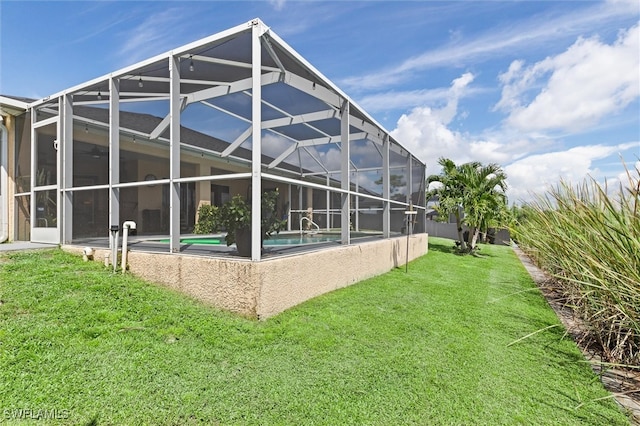 back of property with a yard and a lanai