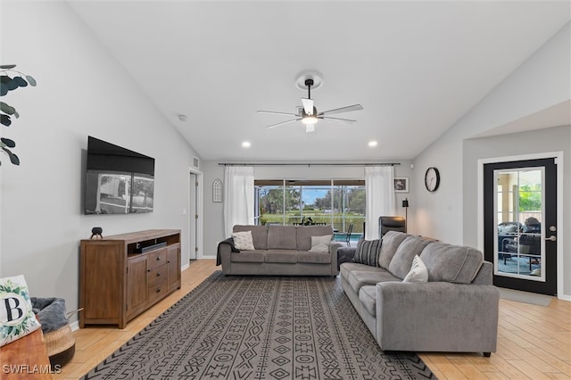 living room with lofted ceiling, a healthy amount of sunlight, ceiling fan, and light hardwood / wood-style floors